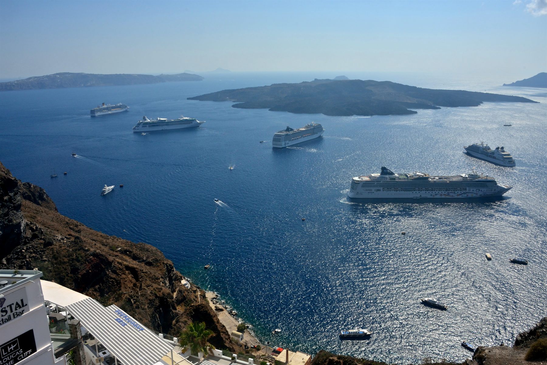 Several large cruise ships anchored in the Santorini caldera
